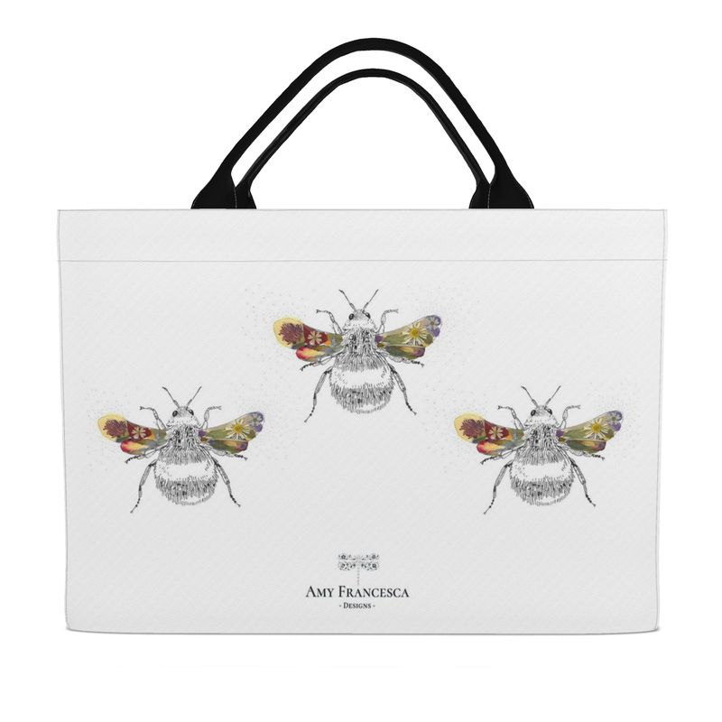 Tote bag featuring three bee illustrations on a white background, shown with black handles.
