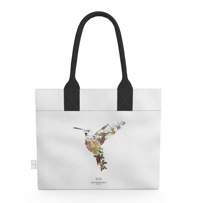 Tote bag featuring a single hummingbird illustration on a white background with black handles.
