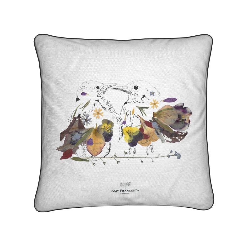 Cushion featuring two birds facing each other on a white background.