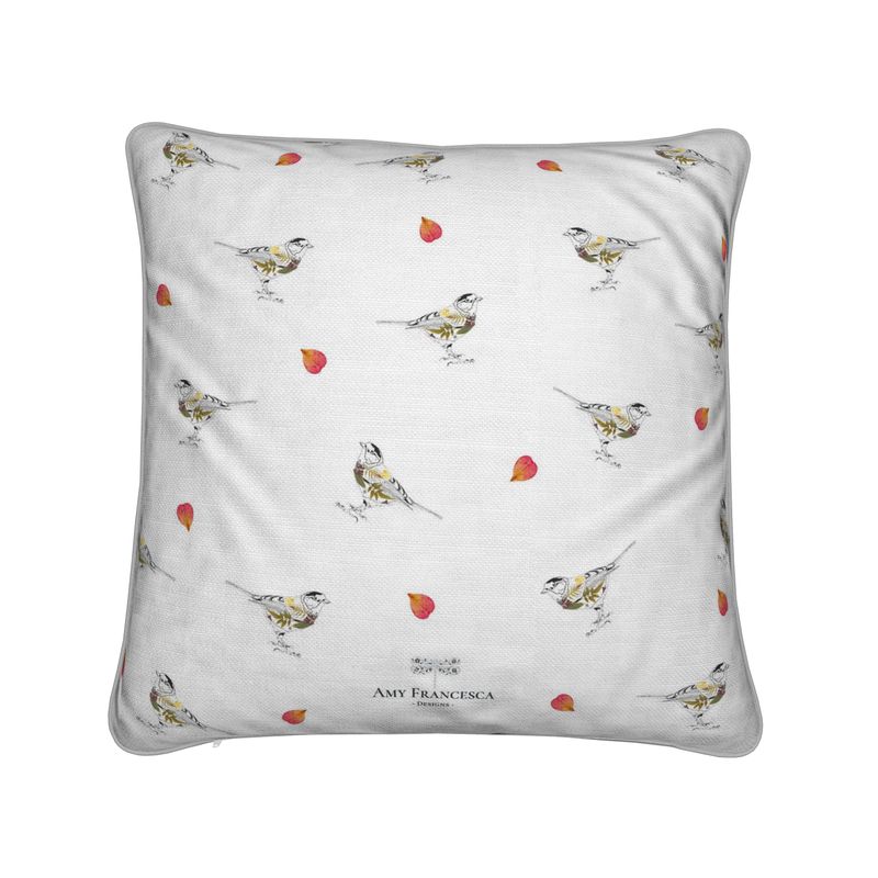 Cushion featuring a repeating bird and petal pattern on a white background.