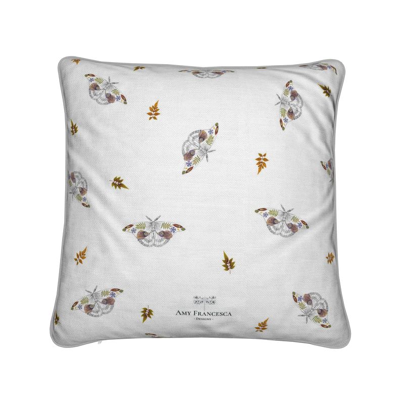 Cushion featuring a repeating moth pattern on a white background.