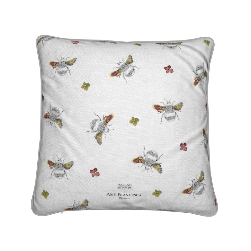 Cushion featuring a repeating bee pattern on a white background.