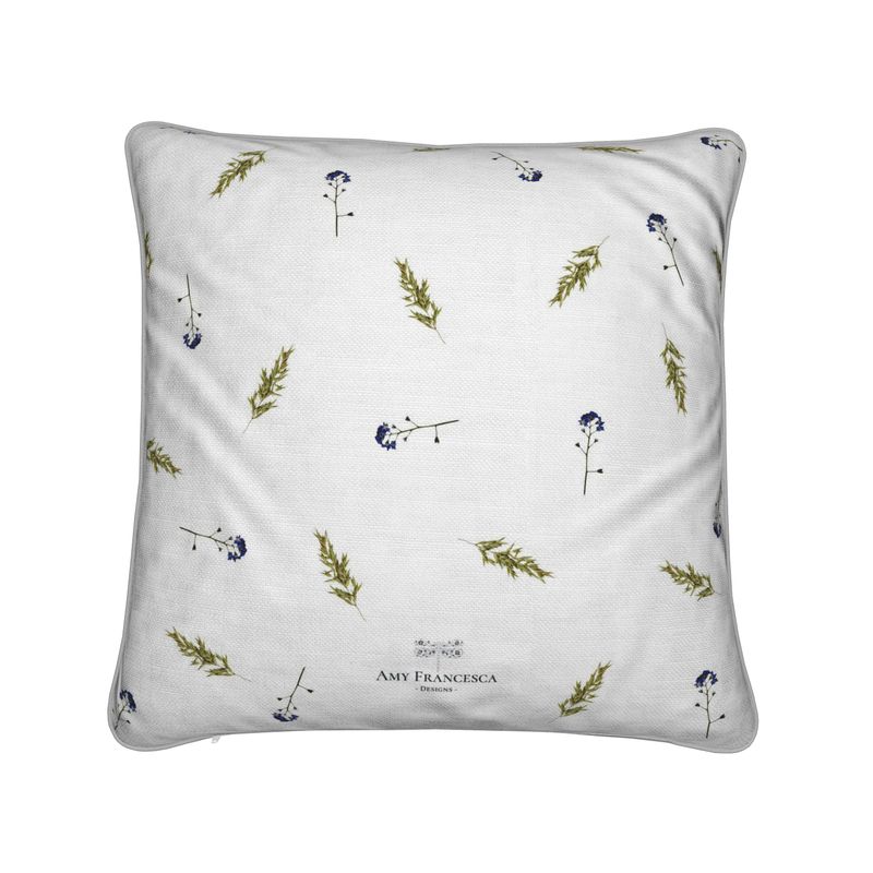 Cushion featuring a repeating botanical pattern on a white background.
