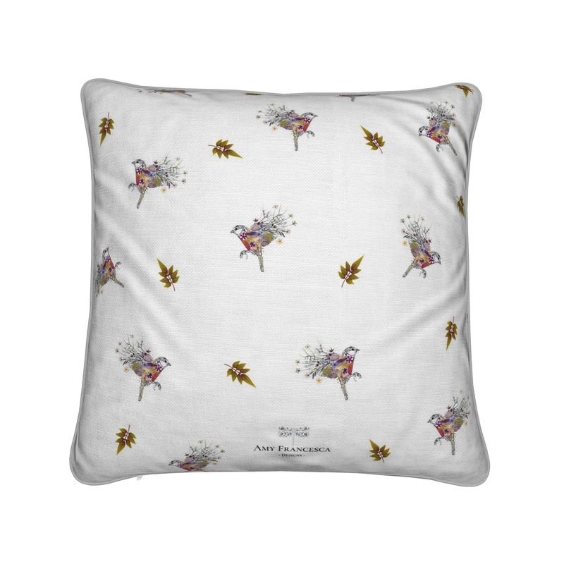 Cushion featuring a repeating bird pattern on a white background.